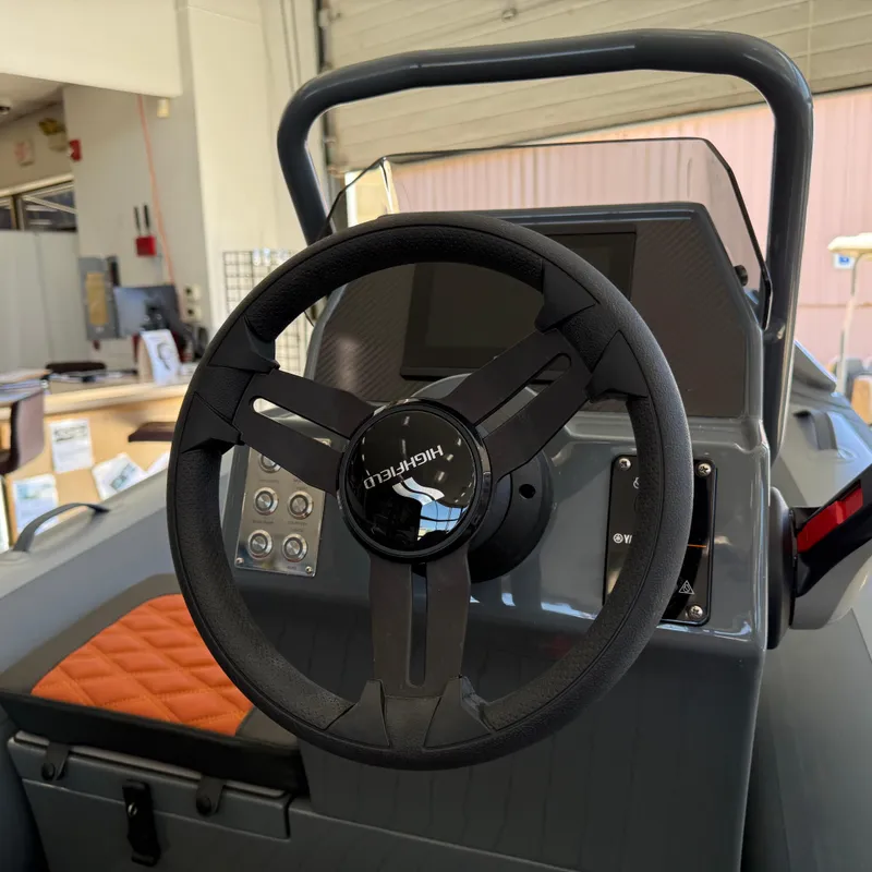 Slide: The Image of Steering wheel of 2025 Highfield Sport 360 boat, featuring modern dashboard controls. - 6