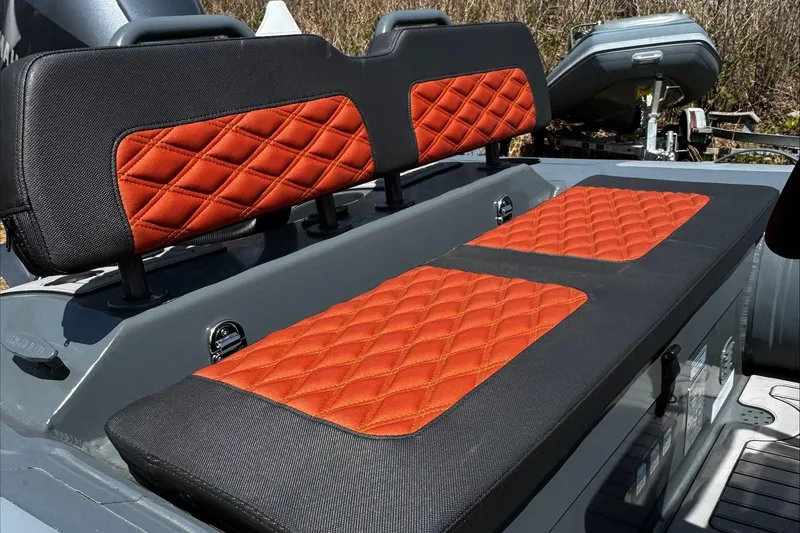 Slide: The Image of 2025 Highfield Sport 460 boat seats with orange diamond-pattern upholstery. - 5