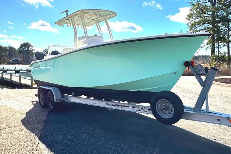 The Image of 2006 KenCraft 230 SEA KING boat on trailer, light blue hull, sunny day. - 1