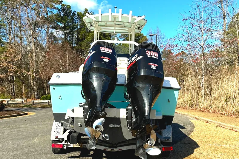Slide: The Image of 2006 KenCraft 230 SEA KING boat with dual outboard motors, parked outdoors. - 10
