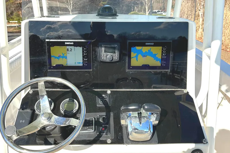 Slide: The Image of KenCraft 230 SEA KING 2006 boat dashboard with navigation screens and steering wheel. - 19