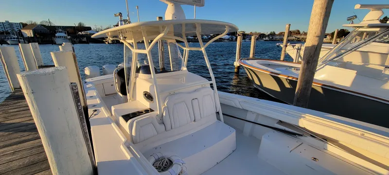 Slide: The Image of 2018 Regulator 34SS boat docked at marina, sunny day, calm waters. - 5