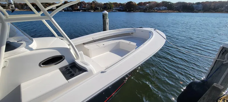 Slide: The Image of 2018 Regulator 34SS boat docked on calm water. - 6