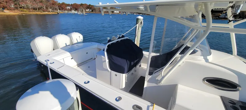 Slide: The Image of 2018 Regulator 34SS boat docked with triple outboard engines. - 8