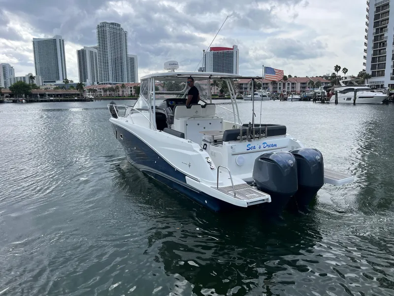 Slide: The Image of 2019 Jeanneau Leader 10.5 boat cruising in urban waterfront setting. - 13