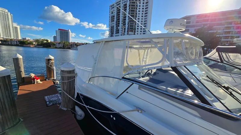 Slide: The Image of 2019 Jeanneau Leader 10.5 docked by waterfront, with city skyline in background. - 18