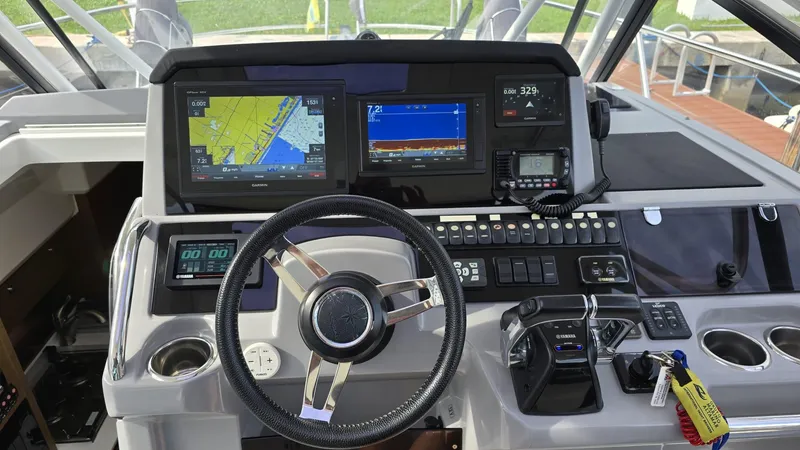 Slide: The Image of Cockpit of 2019 Jeanneau Leader 10.5 with navigation screens and controls. - 2
