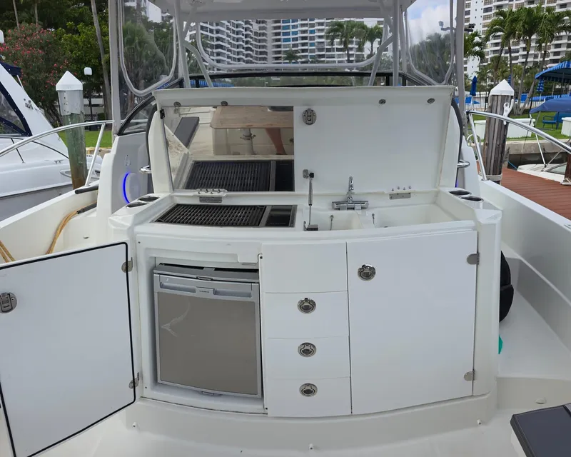 Slide: The Image of 2019 Jeanneau Leader 10.5 boat kitchenette with sink, grill, and storage compartments. - 3
