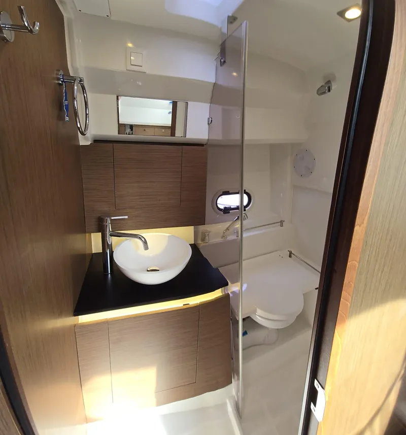 Slide: The Image of 2019 Jeanneau Leader 10.5 bathroom with modern fixtures and wood accents. - 8