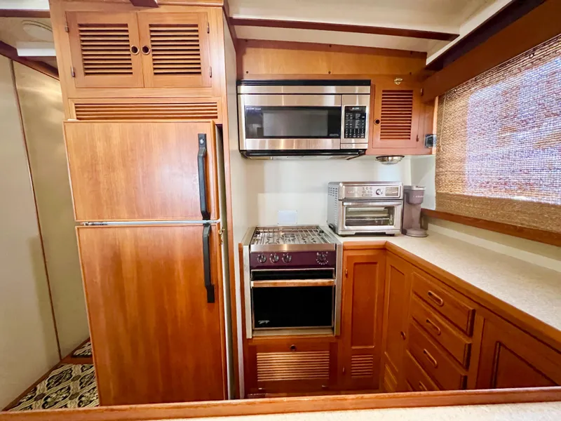 Slide: The Image of Kadey-Krogen 48 Whaleback 2001 yacht kitchen with wood cabinetry and modern appliances. - 13