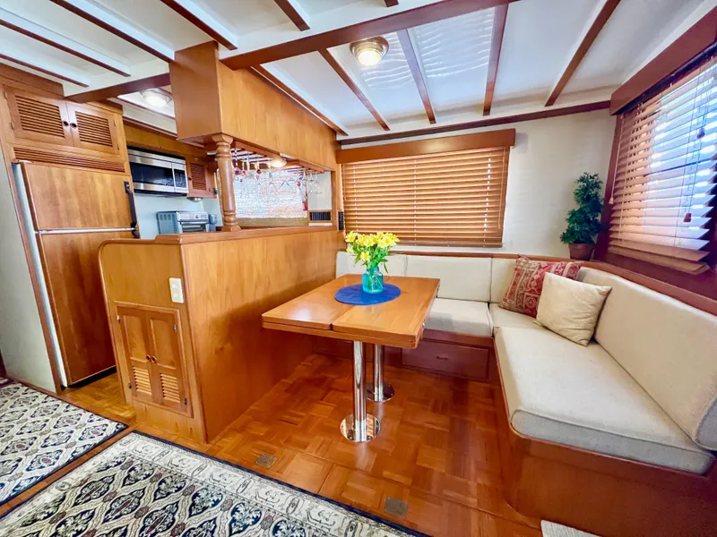 Slide: The Image of Kadey-Krogen 48 Whaleback 2001 interior with cozy dining area and wooden accents. - 15