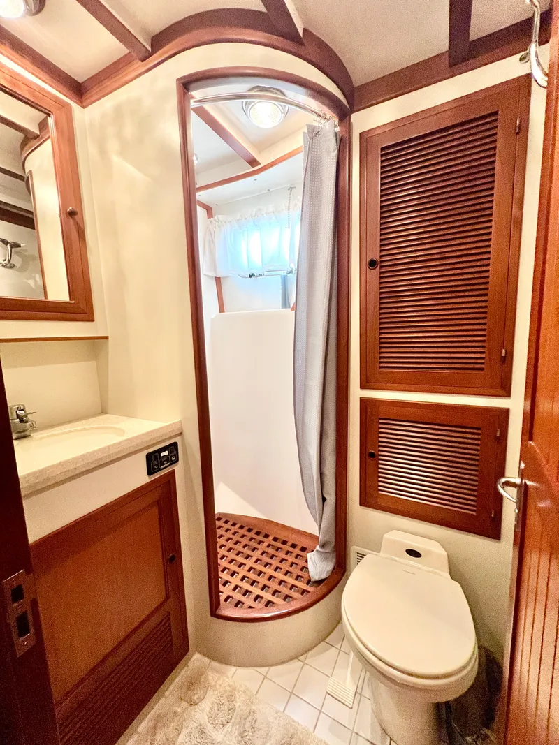 Slide: The Image of 2001 Kadey-Krogen 48 Whaleback yacht bathroom with shower, sink, and toilet. - 17