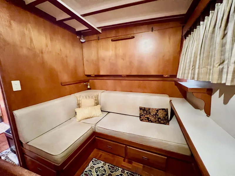 Slide: The Image of 2001 Kadey-Krogen 48 Whaleback interior with cozy seating and wooden cabinetry. - 20
