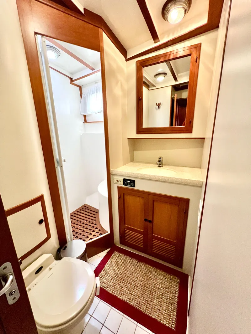 Slide: The Image of 2001 Kadey-Krogen 48 Whaleback yacht bathroom with wood accents and modern fixtures. - 23