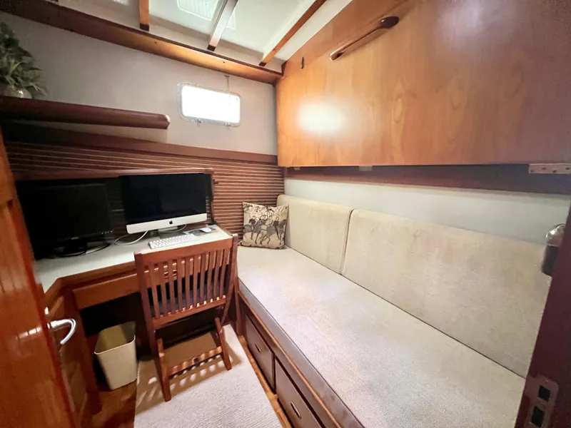 Slide: The Image of Cozy interior of 2001 Kadey-Krogen 48 Whaleback with desk, chair, and sofa. - 25