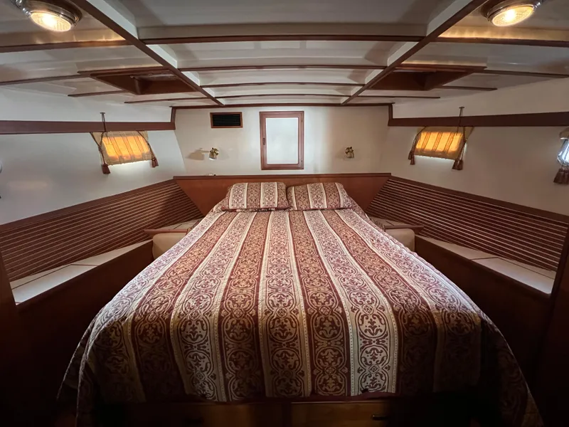 Slide: The Image of Luxurious 2001 Kadey-Krogen 48 Whaleback cabin with elegant bedding and warm lighting. - 26