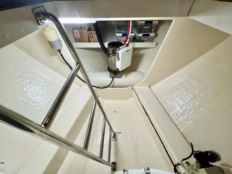 Slide: The Image of Engine room of 2001 Kadey-Krogen 48 Whaleback yacht, featuring ladder and equipment. - 28
