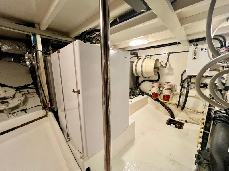 Slide: The Image of Engine room of 2001 Kadey-Krogen 48 Whaleback yacht, featuring equipment and storage. - 29