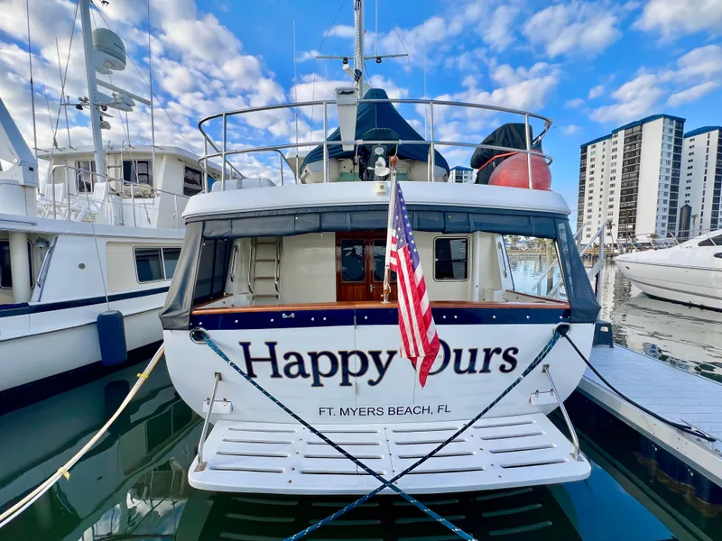 Slide: The Image of Kadey-Krogen 48 Whaleback 2001 yacht docked, displaying "Happy Ours" and American flag. - 3