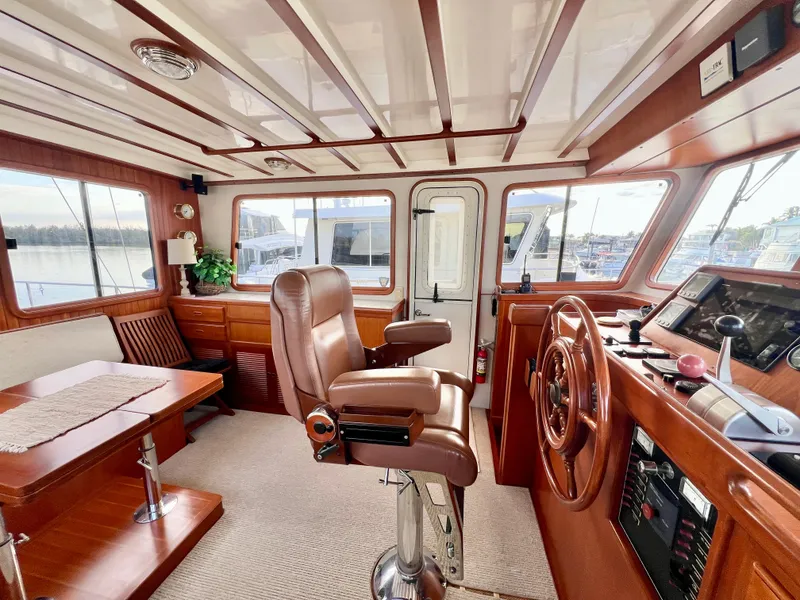 Slide: The Image of Interior of 2001 Kadey-Krogen 48 Whaleback yacht with helm, seating, and dining area. - 31
