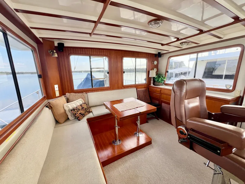 Slide: The Image of Luxurious interior of 2001 Kadey-Krogen 48 Whaleback yacht with plush seating and wooden accents. - 32