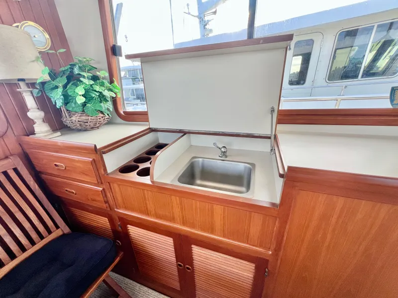 Slide: The Image of Kadey-Krogen 48 Whaleback 2001 yacht interior with wooden cabinetry and sink. - 35