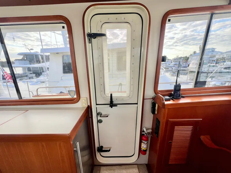 Slide: The Image of Interior view of 2001 Kadey-Krogen 48 Whaleback yacht with door and windows. - 37