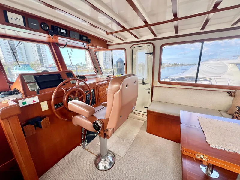 Slide: The Image of Interior of 2001 Kadey-Krogen 48 Whaleback yacht, featuring helm and seating area. - 38