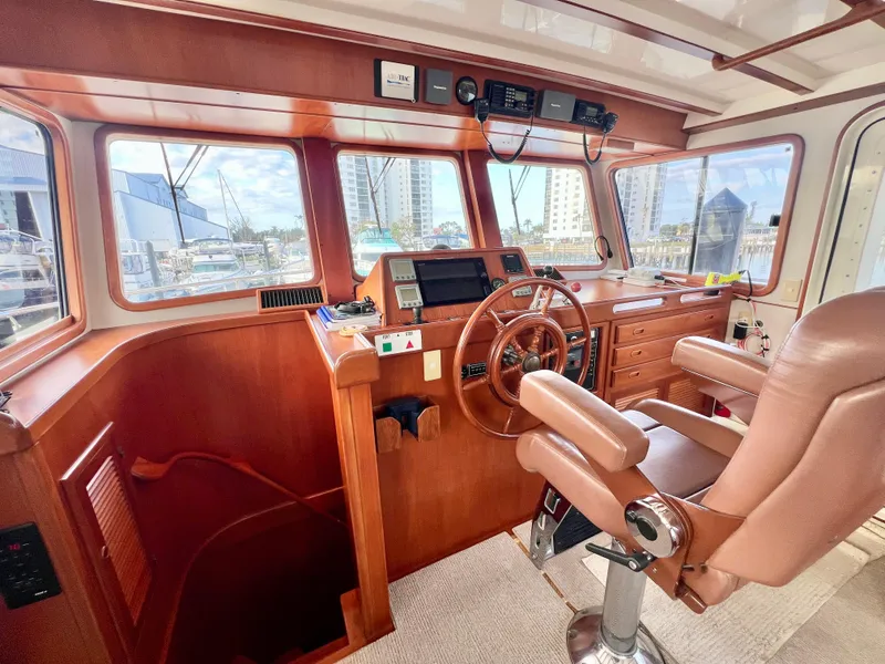 Slide: The Image of Pilothouse interior of 2001 Kadey-Krogen 48 Whaleback yacht with wooden helm and navigation equipment. - 39
