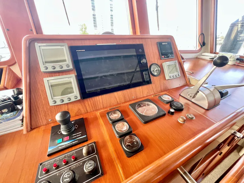 Slide: The Image of Control panel of 2001 Kadey-Krogen 48 Whaleback yacht with navigation instruments and throttle. - 40