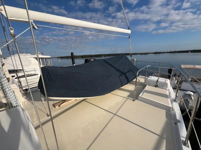 Slide: The Image of Kadey-Krogen 48 Whaleback 2001 yacht deck with blue cover, calm waters, and clear sky. - 42