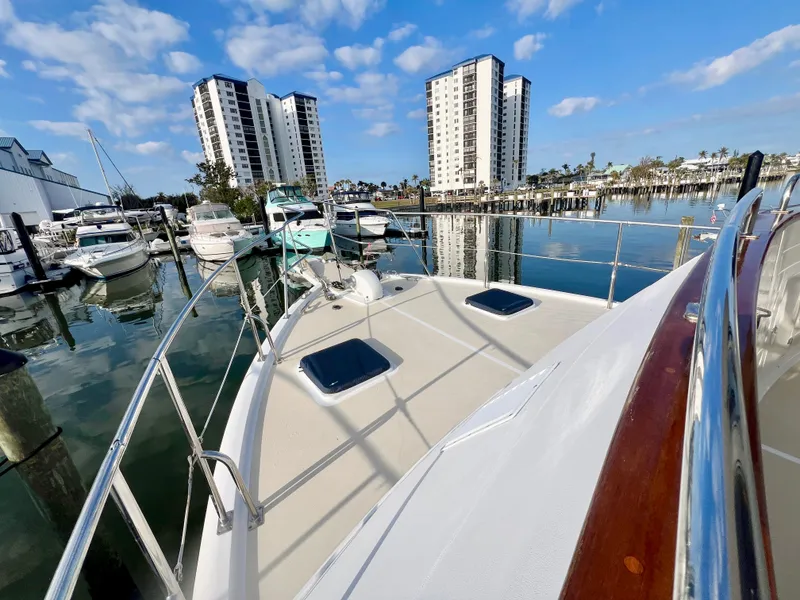Slide: The Image of Kadey-Krogen 48 Whaleback yacht docked in marina, 2001 model, with cityscape background. - 44