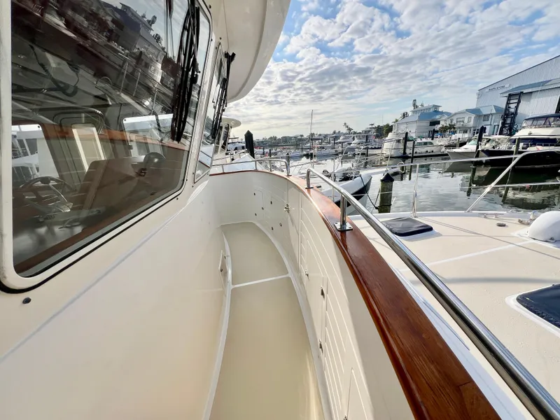 Slide: The Image of 2001 Kadey-Krogen 48 Whaleback yacht docked at marina under cloudy sky. - 45