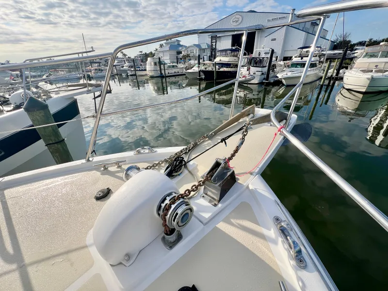 Slide: The Image of Bow of 2001 Kadey-Krogen 48 Whaleback yacht at marina, featuring anchor and winch. - 47