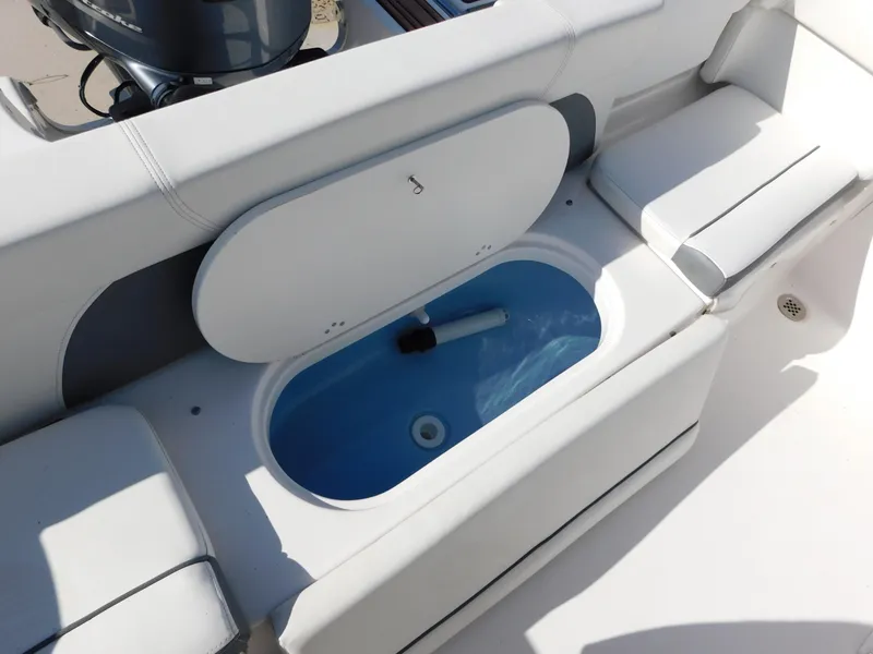 Slide: The Image of 2017 Tidewater 220 LXF boat interior with open storage compartment. - 13