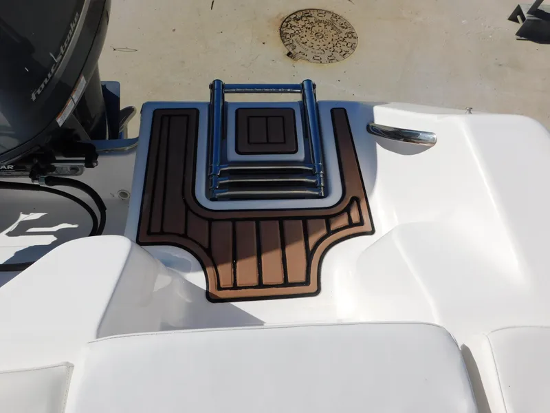 Slide: The Image of 2017 Tidewater 220 LXF boat deck with ladder and wood accents. - 18
