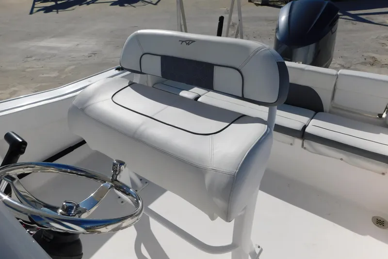 Slide: The Image of 2017 Tidewater 220 LXF boat interior with steering wheel and seating. - 23