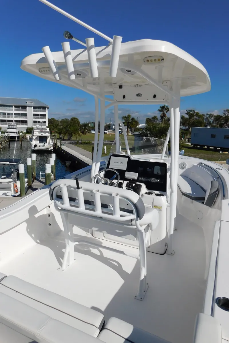 Slide: The Image of 2017 Tidewater 220 LXF boat with center console and T-top, docked at marina. - 26