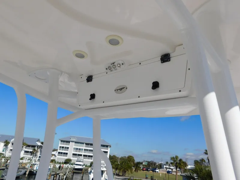 Slide: The Image of 2017 Tidewater 220 LXF boat interior with overhead console and scenic marina view. - 30