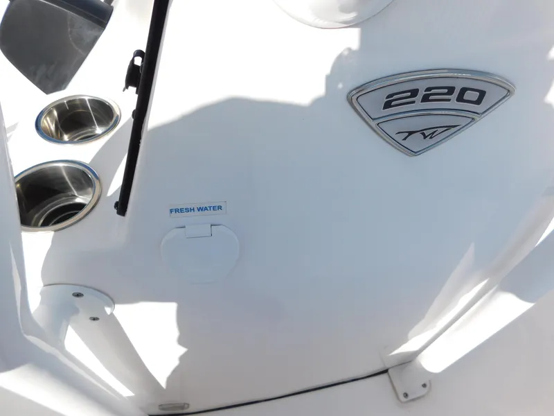 Slide: The Image of Tidewater 220 LXF 2017 boat interior with cup holders and fresh water access. - 31