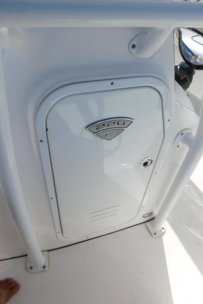 Slide: The Image of 2017 Tidewater 220 LXF boat console with storage compartment. - 32