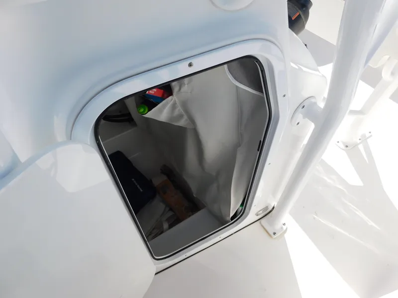 Slide: The Image of 2017 Tidewater 220 LXF boat storage compartment with open hatch. - 33