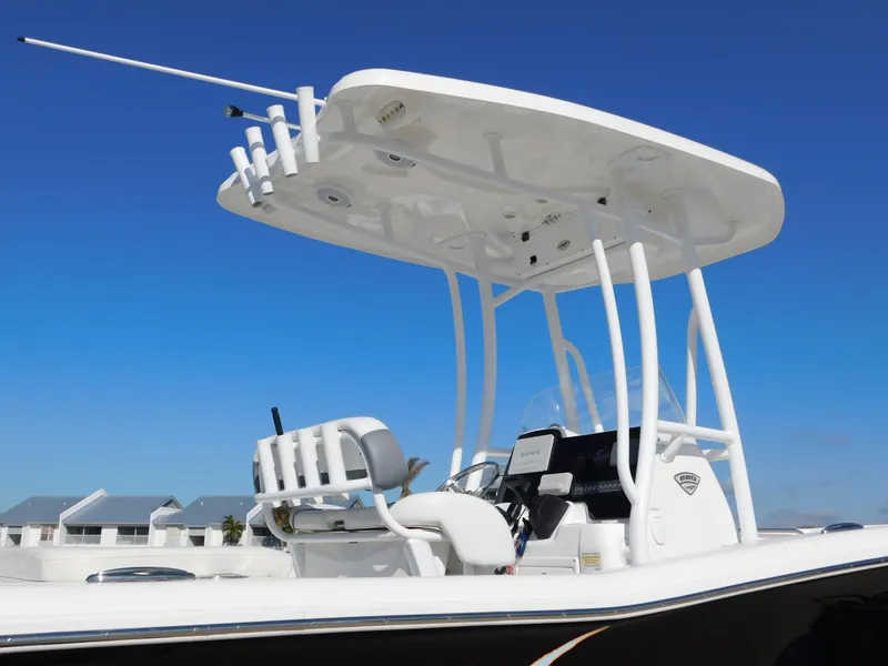 Slide: The Image of 2017 Tidewater 220 LXF boat with T-top and rod holders against clear blue sky. - 6