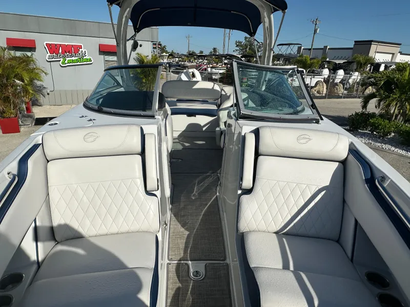 Slide: The Image of 2022 Crownline 260 XSS boat interior with white seating and open deck layout. - 13