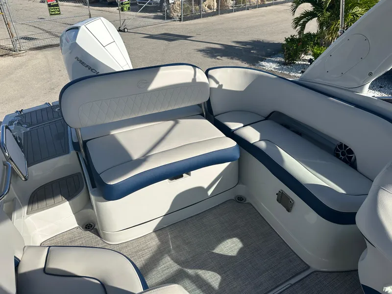 Slide: The Image of 2022 Crownline 260 XSS boat interior with cushioned seating and modern design. - 16