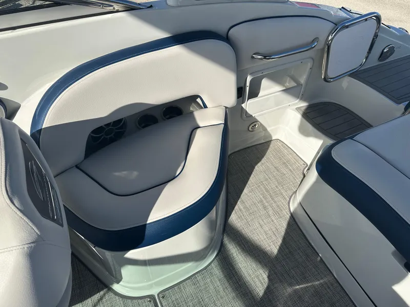 Slide: The Image of Interior seating of 2022 Crownline 260 XSS boat with blue and white upholstery. - 18