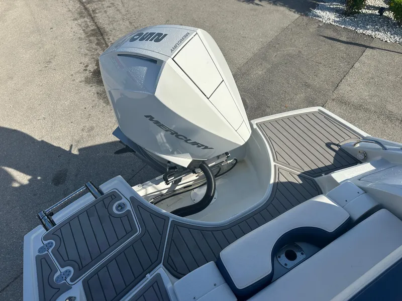 Slide: The Image of 2022 Crownline 260 XSS boat with Mercury outboard engine, featuring sleek deck design. - 19