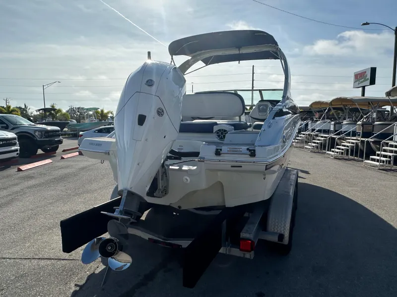 Slide: The Image of 2022 Crownline 260 XSS boat on trailer, rear view, sunny day. - 6
