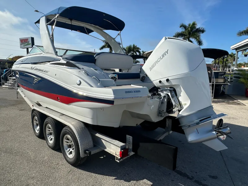 Slide: The Image of 2022 Crownline 260 XSS boat on trailer with Mercury outboard motor. - 7