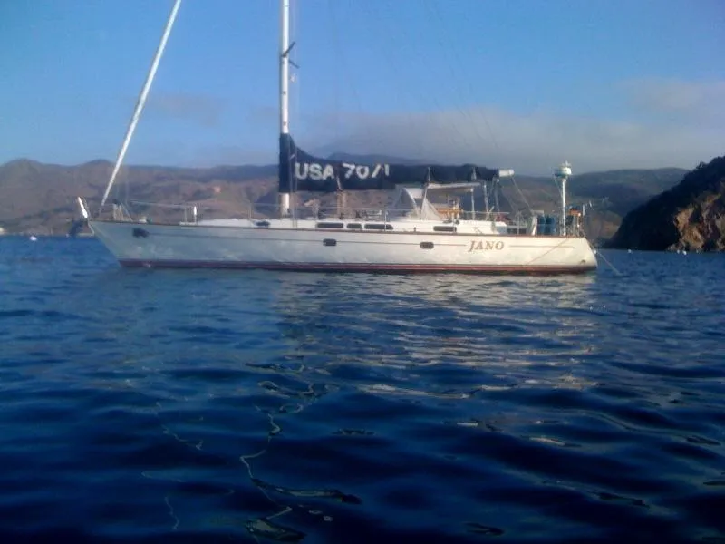 Slide: The Image of Sailing yacht Farr 55, 1994 model, anchored in calm waters. - 1